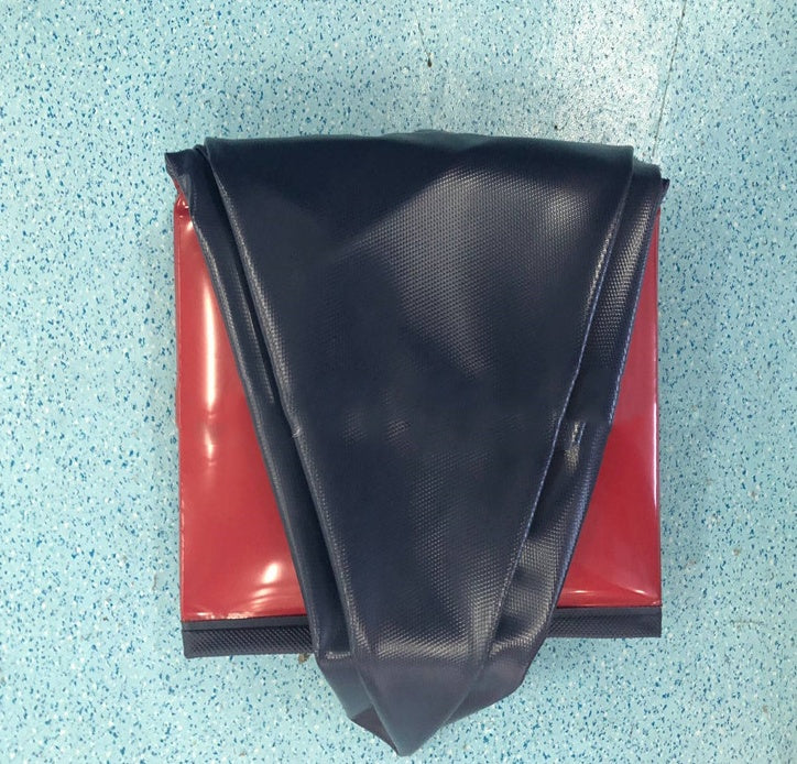 Black fabric on a red surface with a textured blue background