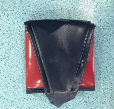 Black fabric on a red surface with a textured blue background